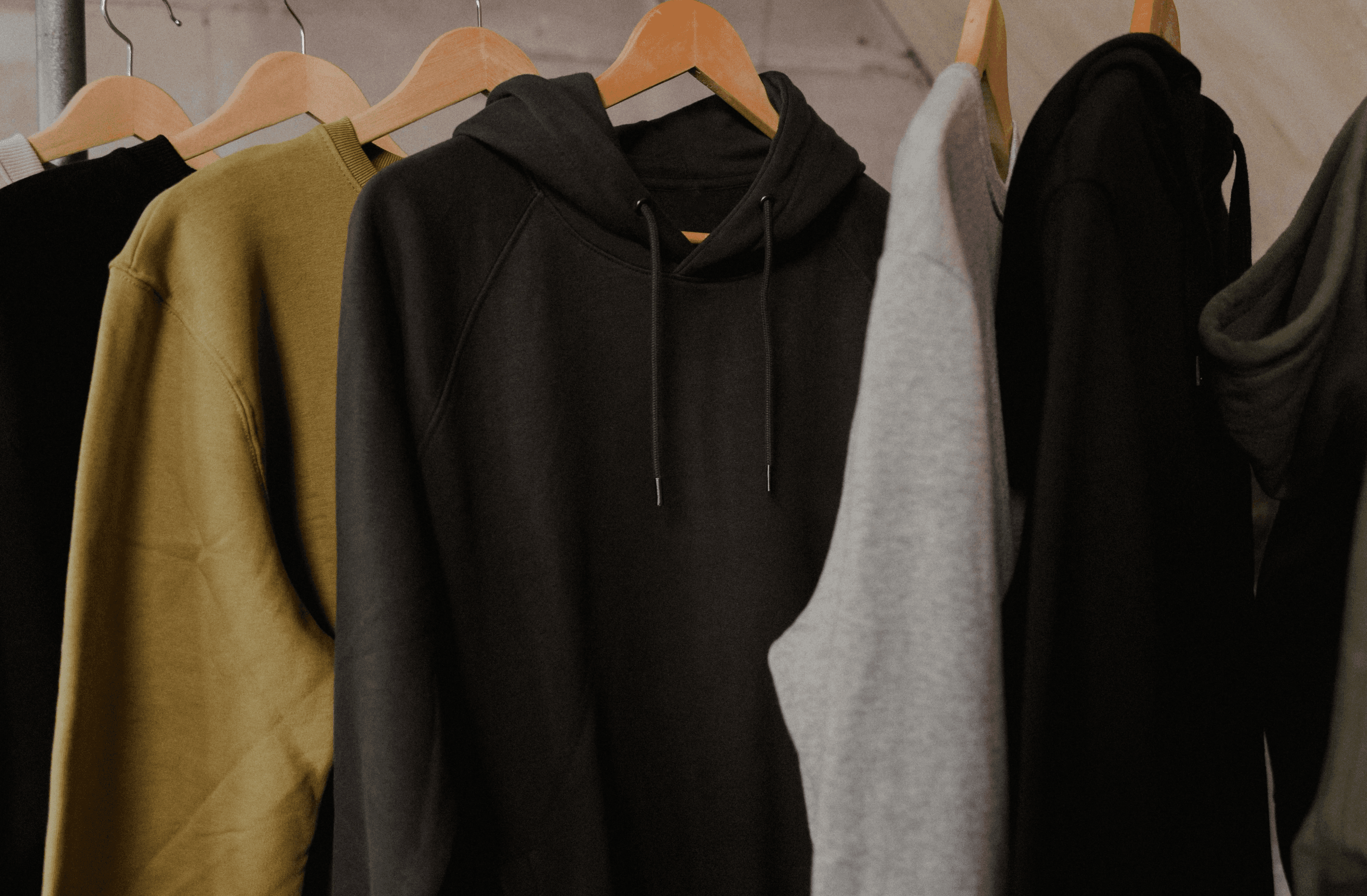 About Us - Apparel hanging on rack